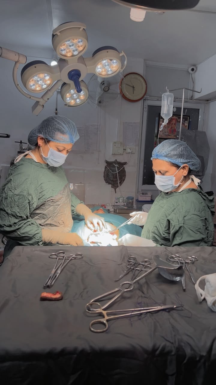 Surgical team performing an operation in the operating theatre at Aashirwad Hospital, Bhopal